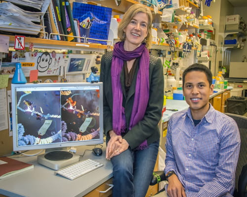 Two people sitting in front of a computer.