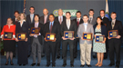 2011 PECASE winners holding their awards standing with DOE leadership on a stage (Ceremony: 8/1/12).