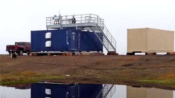 Instruments take atmospheric measurements from the roof of a new Department of Energy climate observation station at Oliktok Point, Alaska.