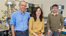 Three scientists in front of a Center for Functional Nanomaterials instrument.
