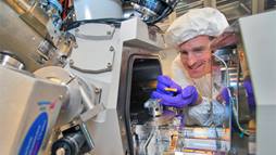 A scientist working with a focused-ion beam instrument.