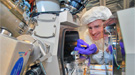 A scientist working with a focused-ion beam instrument.