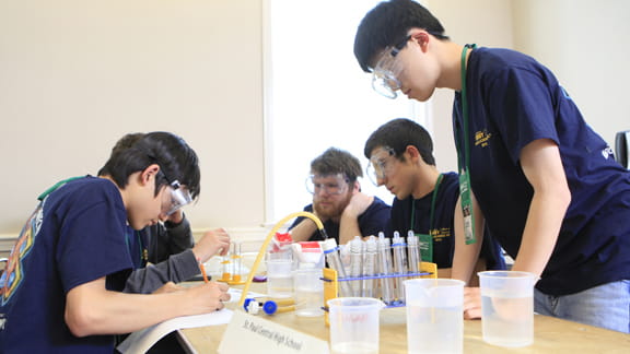 A group of students gathered around a table.
