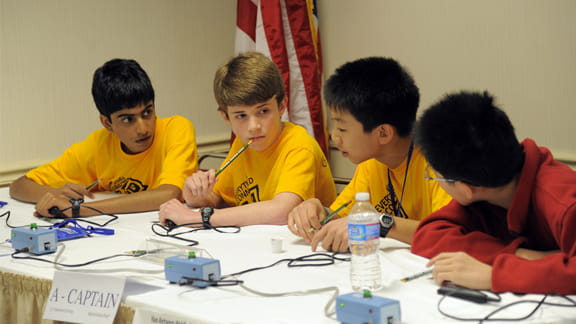 A group of students sitting at table.