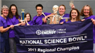 A group of students and teachers holding a banner that reads "National Science Bowl 2013 Regional Champion".