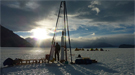 Ice core driller Tanner Kuhl works with the blue ice drill on Taylor Glacier in Antarctica.