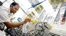 Argonne physicist Mahalingam Balasubramanian loads an in situ lithium-ion battery into the low-energy resolution inelastic X-ray (LERIX) system at the Advanced Photon Source. 