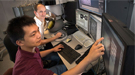Stony Brook University graduate student Qiyuan Wu and Brookhaven Lab Center for Functional Nanomaterials (CFN) staff scientist Dmitri Zakharov studying samples at the Titan Environmental Transmission Electron Microscope at the CFN.