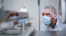 SLAC engineer Corey Hardin inspects one of the newly-arrived mirrors in a clean room facility.