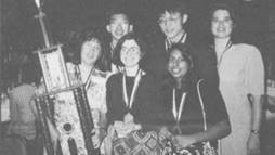 Left to right, in the back: Si Hwang Chin, Peter Chan, Renee Landrum. Front row: coach Penny Sconzo, Susan Born, and Shireen Haque with their 1994 National Science Bowl® trophy.