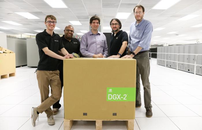 (From left to right) Cole Freniere and Michael Reynolds of Microway, Alex Volkov of NVIDIA, and Chris Layton and Brian Zachary of ORNL pose with a newly arrived DGX-2. The NVIDIA appliances connect ORNL researchers with a platform that excels at machine learning, a type of artificial intelligent that could automate some of the time-intensive analysis inherent in scientific research.