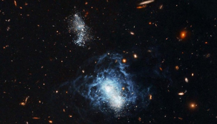 The most direct — and thus most solid — prediction of Big Bang nucleosynthesis concerns helium-4, each nucleus of which consists of two protons and two neutrons. However, helium-4 is also a standard product of stellar nuclear fusion. In order to infer the primordial helium-4 abundance, astronomers turn to certain dwarf galaxies. This image shows an important example, the galaxy "I Zwicky 18," a dwarf galaxy rather close to us by intergalactic standards, a mere 45 million light years away. Image courtesy of NASA (Download Image)