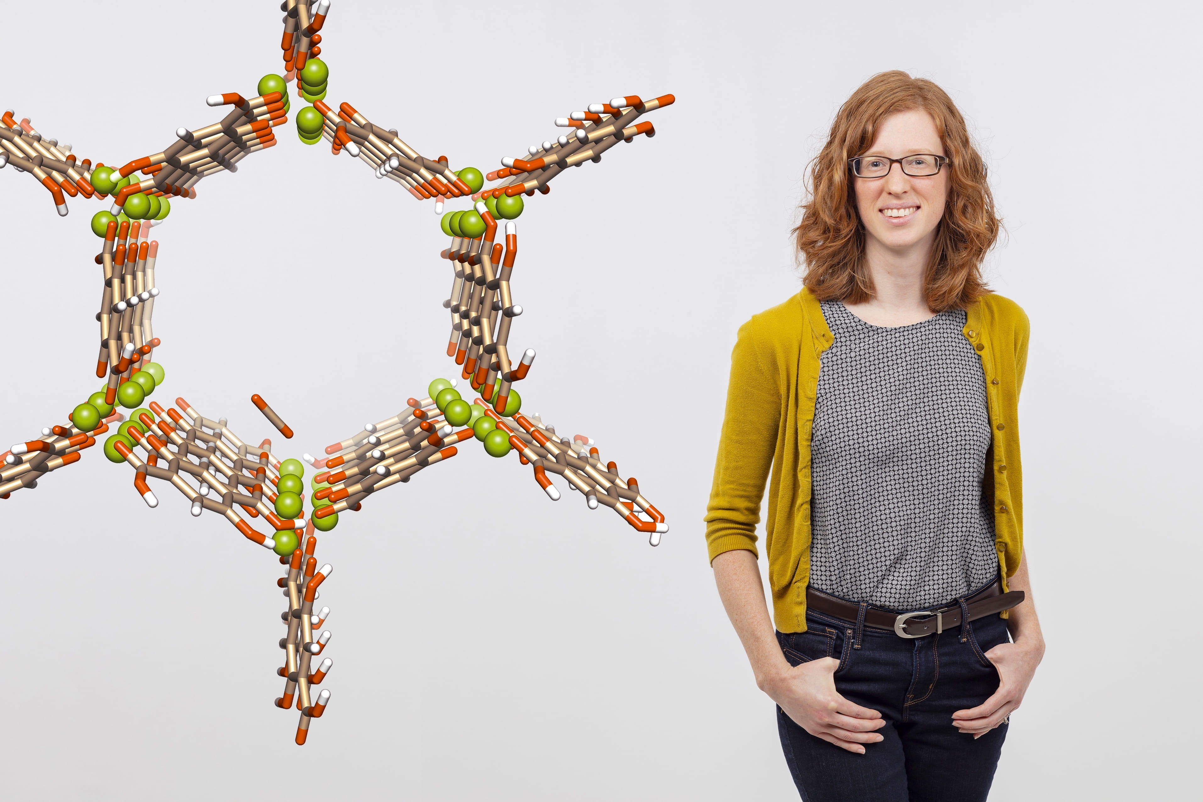 a visualization of a magnesium-based MOF made up of magnesium ions (green) and organic linkers consisting of carbon (tan), oxygen (orange), and hydrogen (white) atoms, and Ashleigh Barnes