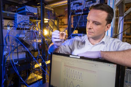Daniel Bowring holds up a component for detecting dark matter particles called axions. Photo: Reidar Hahn