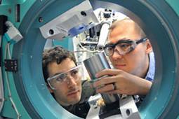 Two scientists working on Argonne's Advanced Photon Source