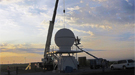 A crane positions the topmost portion of the X-band scanning ARM precipitation radar (X-SAPR).