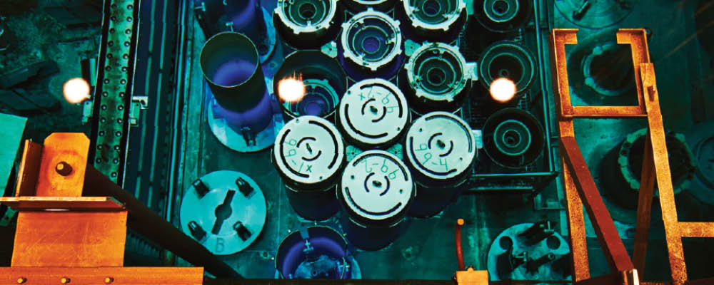 A blue glow from Cherenkov radiation in the reactor pool of the High Flux Isotope Reactor from stored fuel elements.